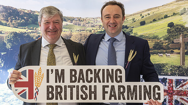 Danny holding a sign saying 'I'm backing British Farming'