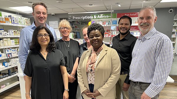 Danny and Richard Murphy with staff at pharmacy