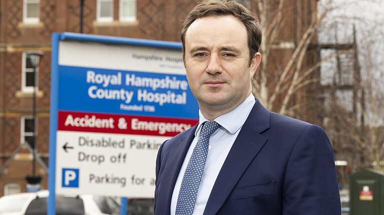 Danny standing in front of the RHCH sign