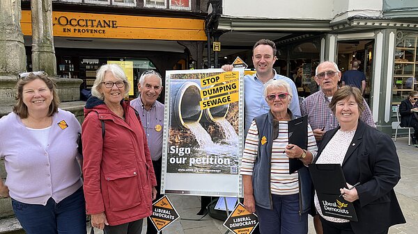Lib Dem campaigner collecting petition signatures against sewage dumping